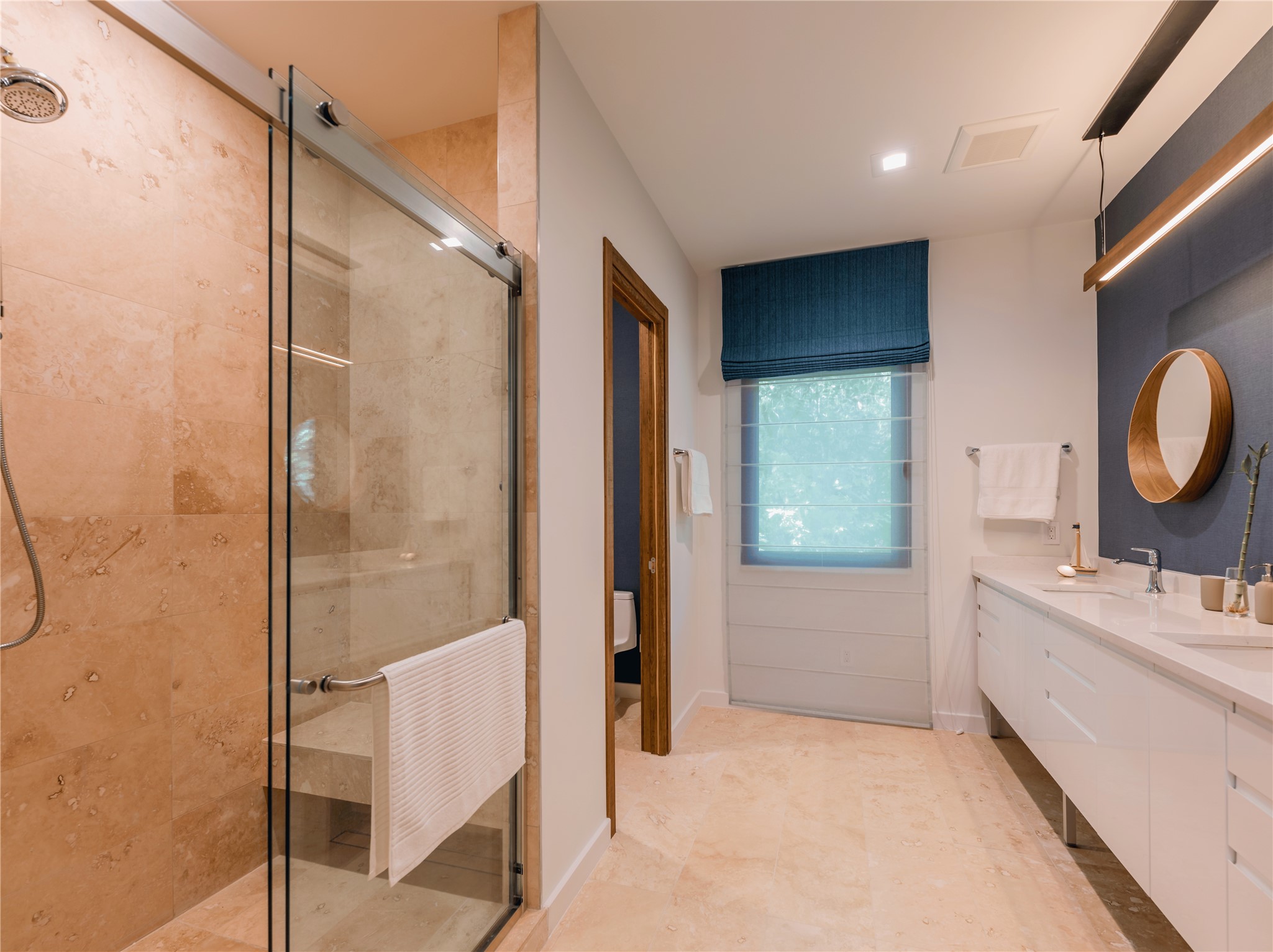 2806 Geronimo Trail Austin, TX 78734 - Photo 16 of 36 a bathroom with a double vanity sink a mirror and shower