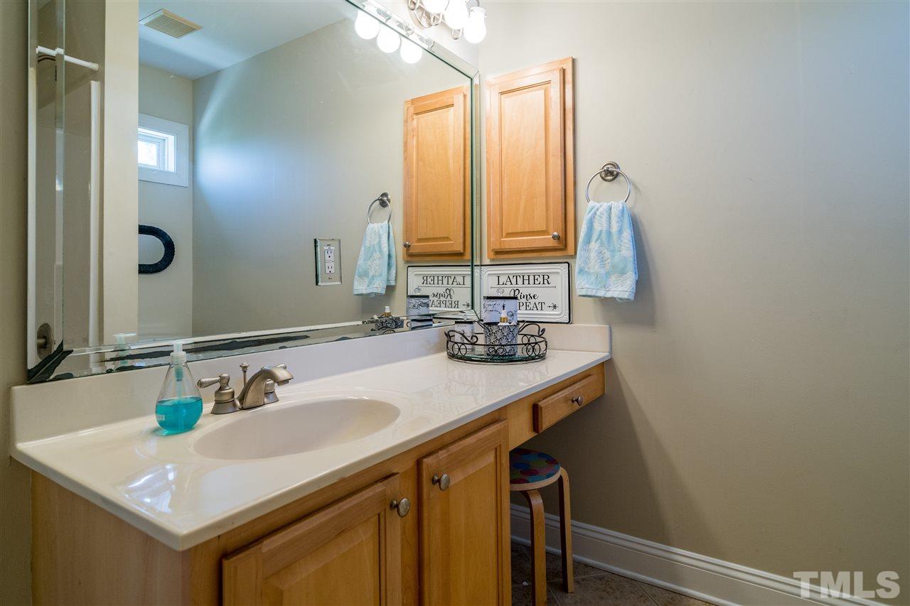 275 Waterville Street Raleigh, NC 27603 - Photo 22 of 30 a bathroom with a sink and a mirror