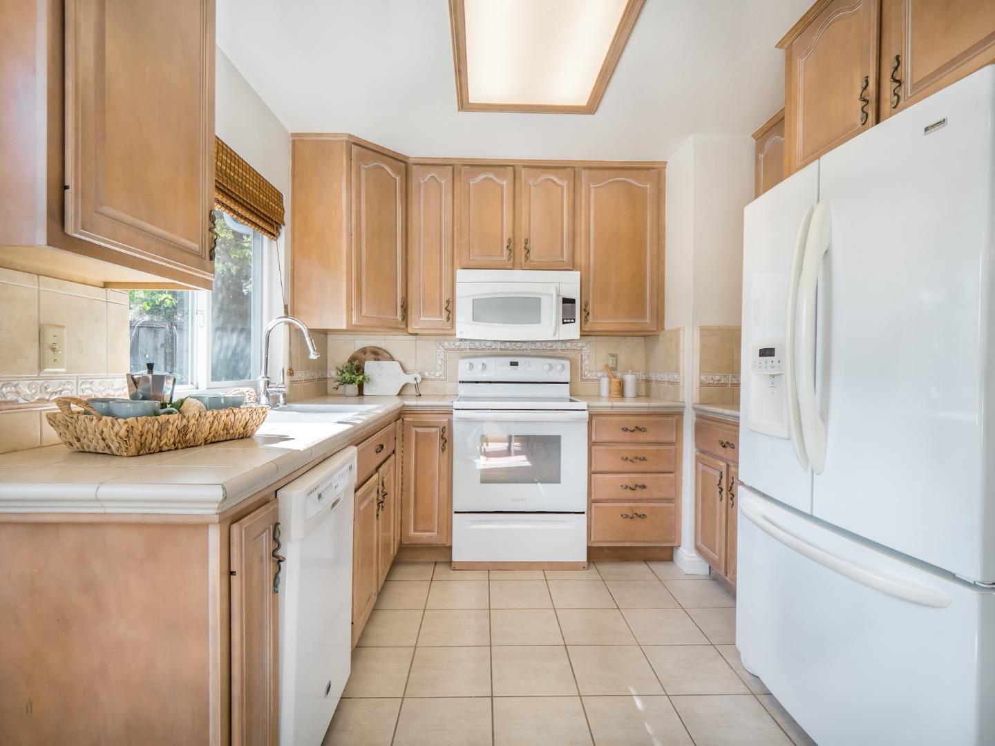 280 Marlin Court Aptos, CA 95003 - Photo 15 of 43 a kitchen with white cabinets and white appliances