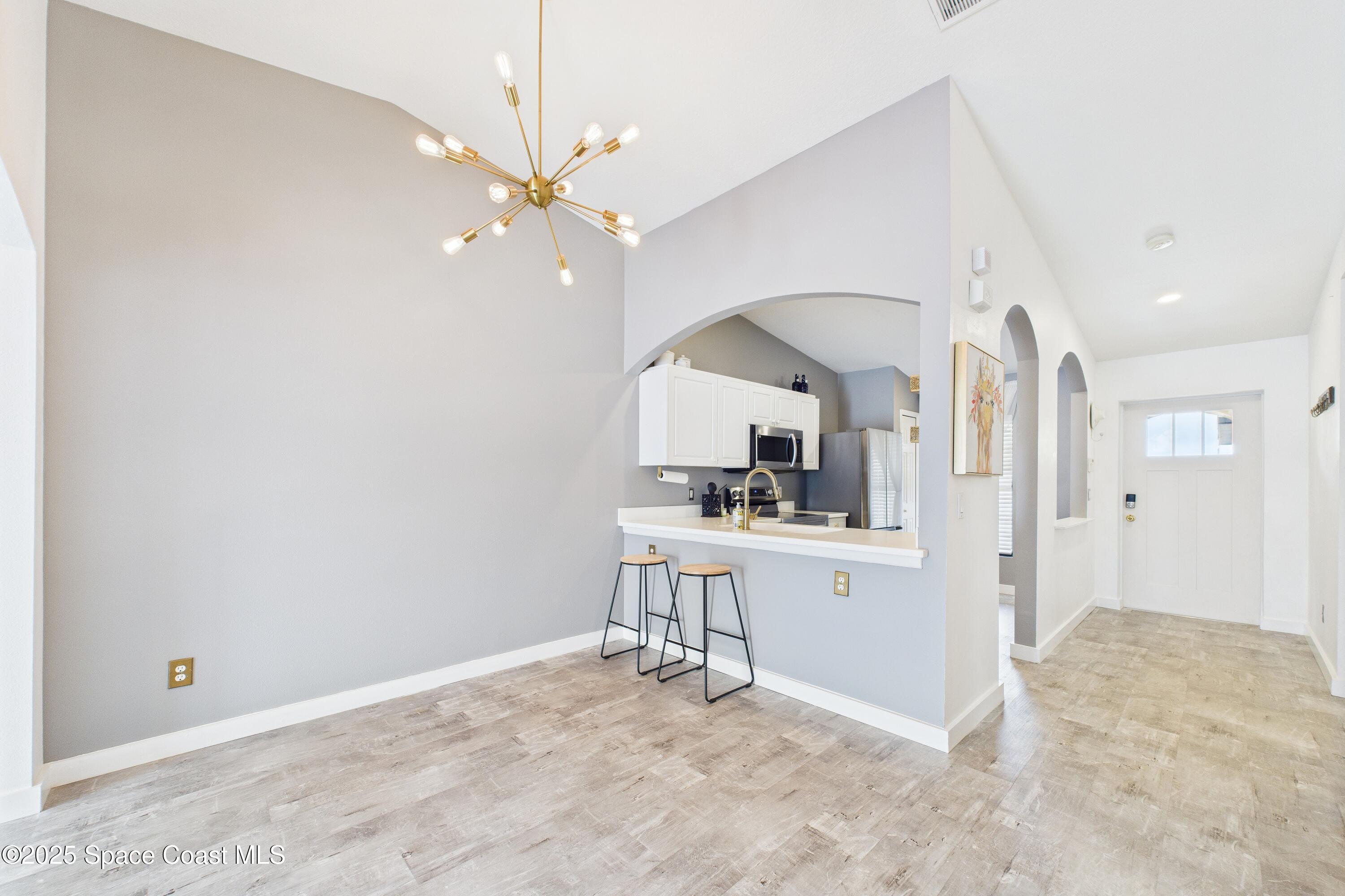 1010 Luminary Circle, Unit 104 Melbourne, FL 32901 - Photo 15 of 42 a view of kitchen with sink microwave and cabinets