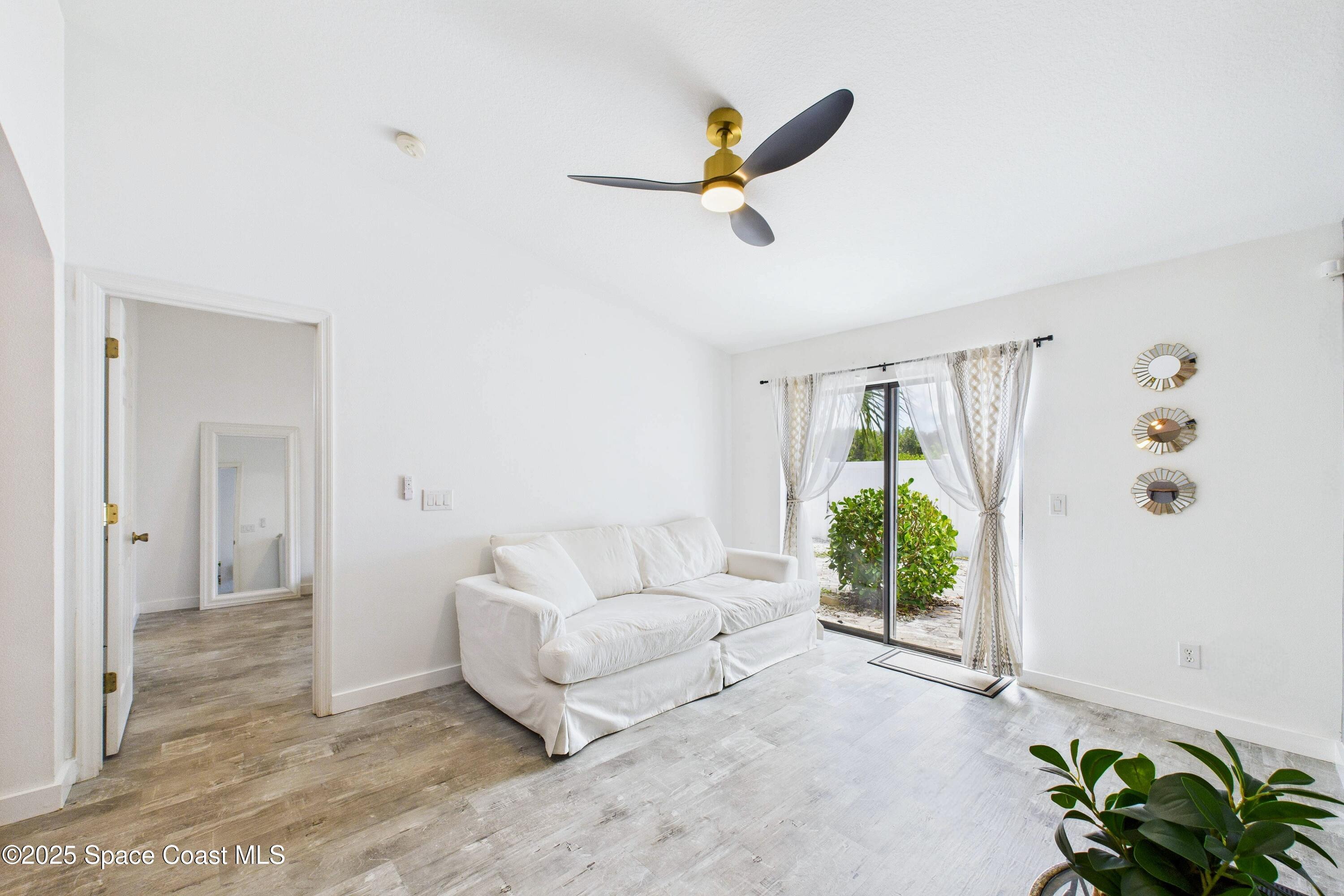 1010 Luminary Circle, Unit 104 Melbourne, FL 32901 - Photo 17 of 42 a living room with furniture and a large window