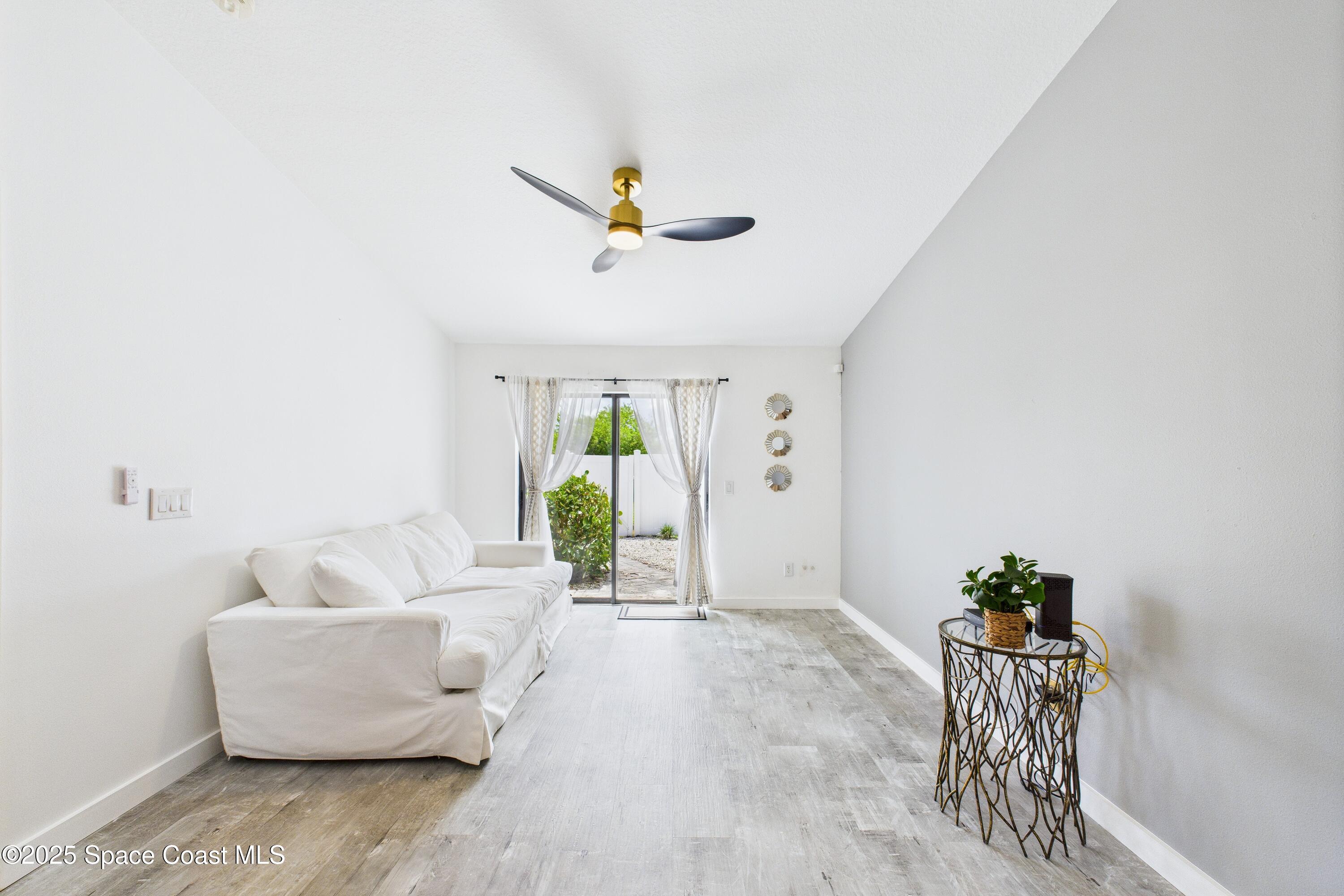 1010 Luminary Circle, Unit 104 Melbourne, FL 32901 - Photo 18 of 42 a living room with furniture and a potted plant