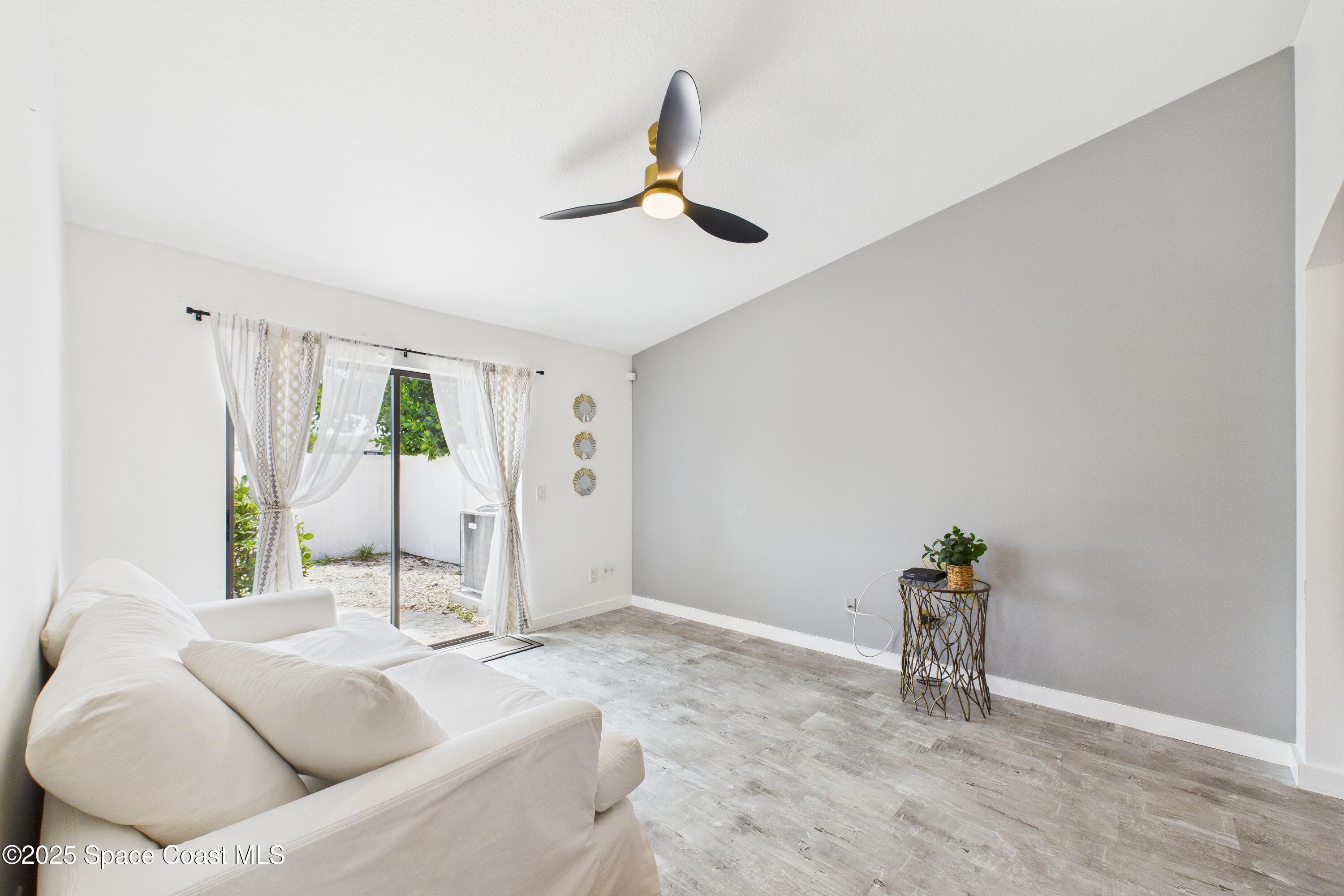 1010 Luminary Circle, Unit 104 Melbourne, FL 32901 - Photo 19 of 42 a living room with furniture and a window