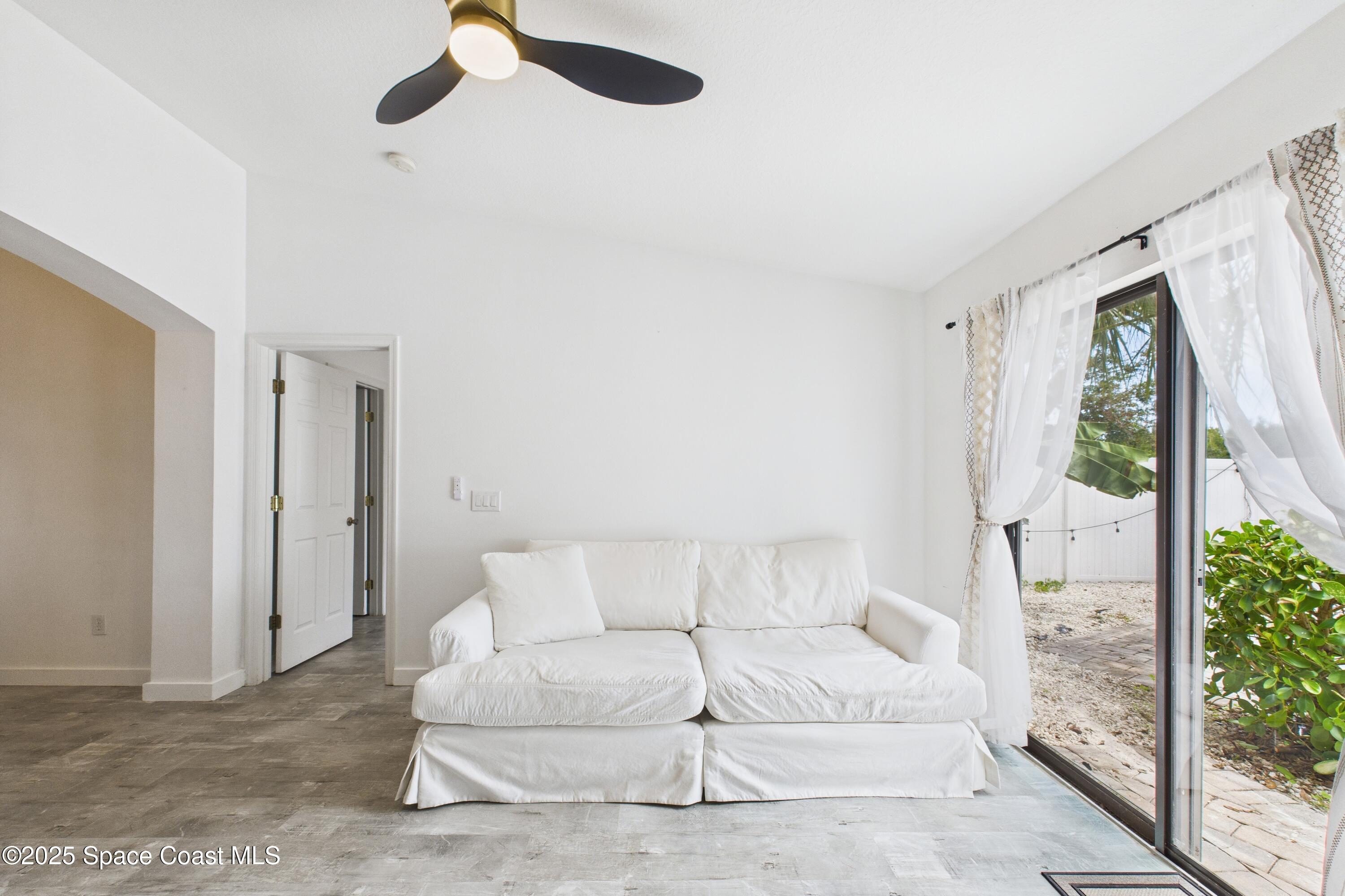 1010 Luminary Circle, Unit 104 Melbourne, FL 32901 - Photo 21 of 42 a living room with furniture and a large window