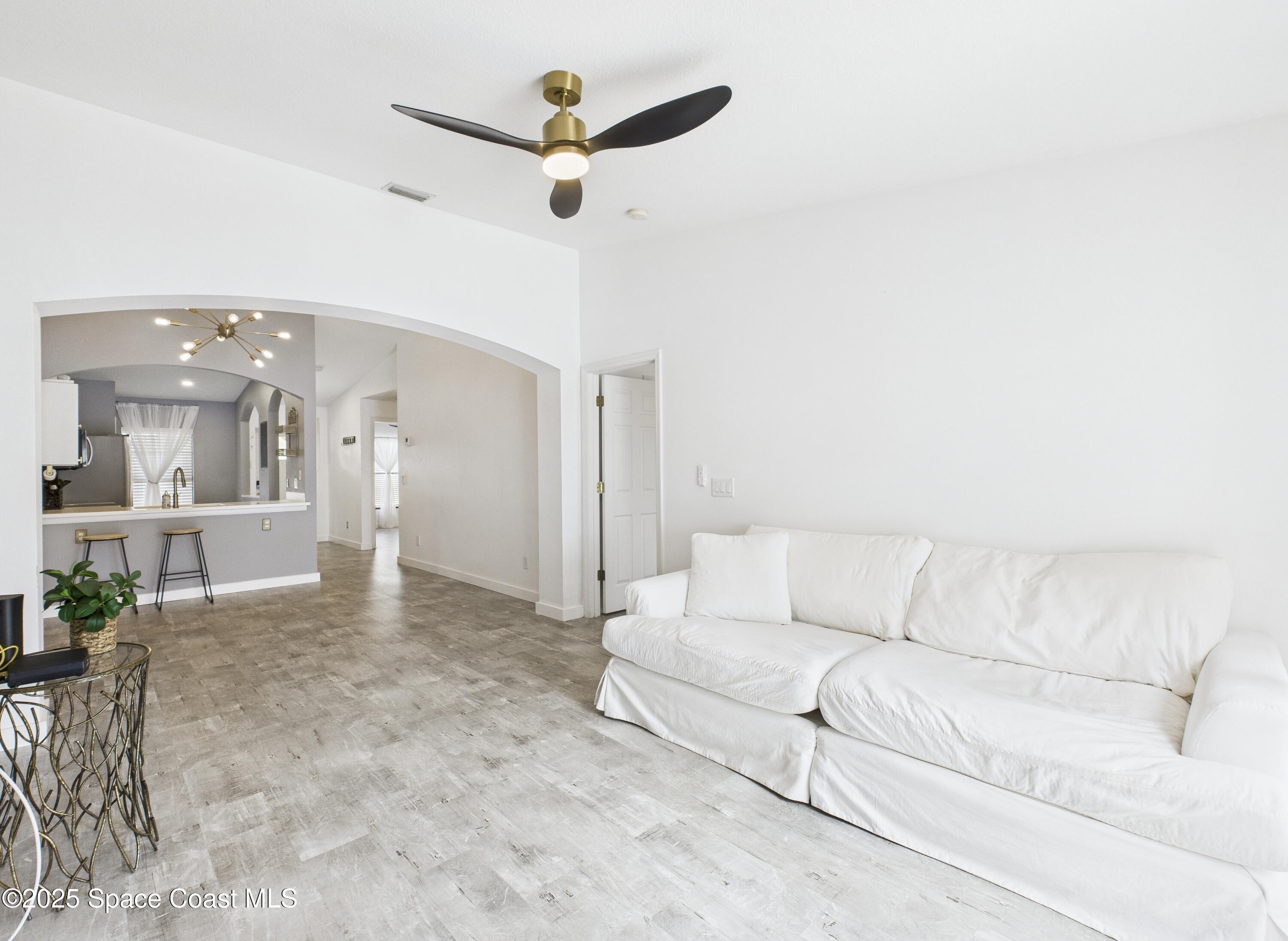 1010 Luminary Circle, Unit 104 Melbourne, FL 32901 - Photo 23 of 42 a living room with furniture and a ceiling fan
