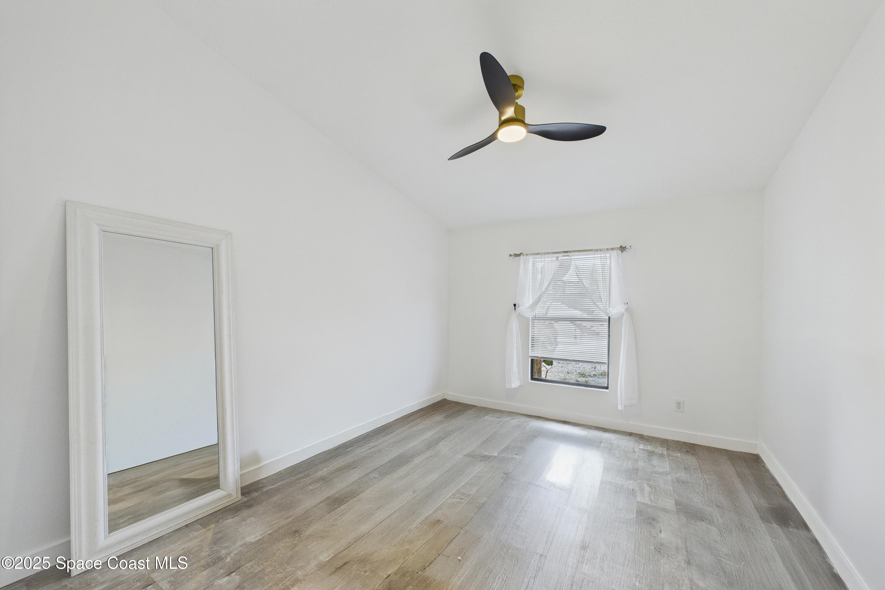 1010 Luminary Circle, Unit 104 Melbourne, FL 32901 - Photo 26 of 42 an empty room with a empty space and windows