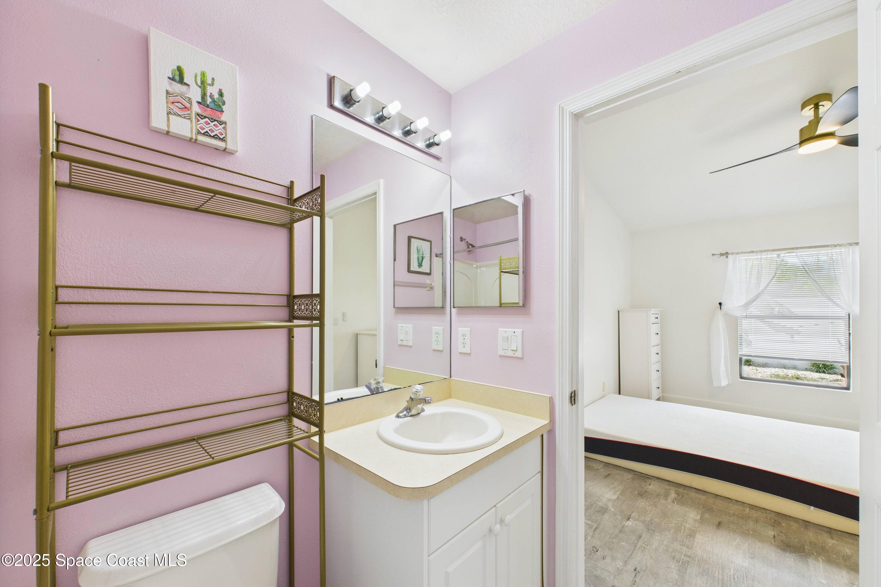 1010 Luminary Circle, Unit 104 Melbourne, FL 32901 - Photo 30 of 42 a bathroom with a sink and a mirror