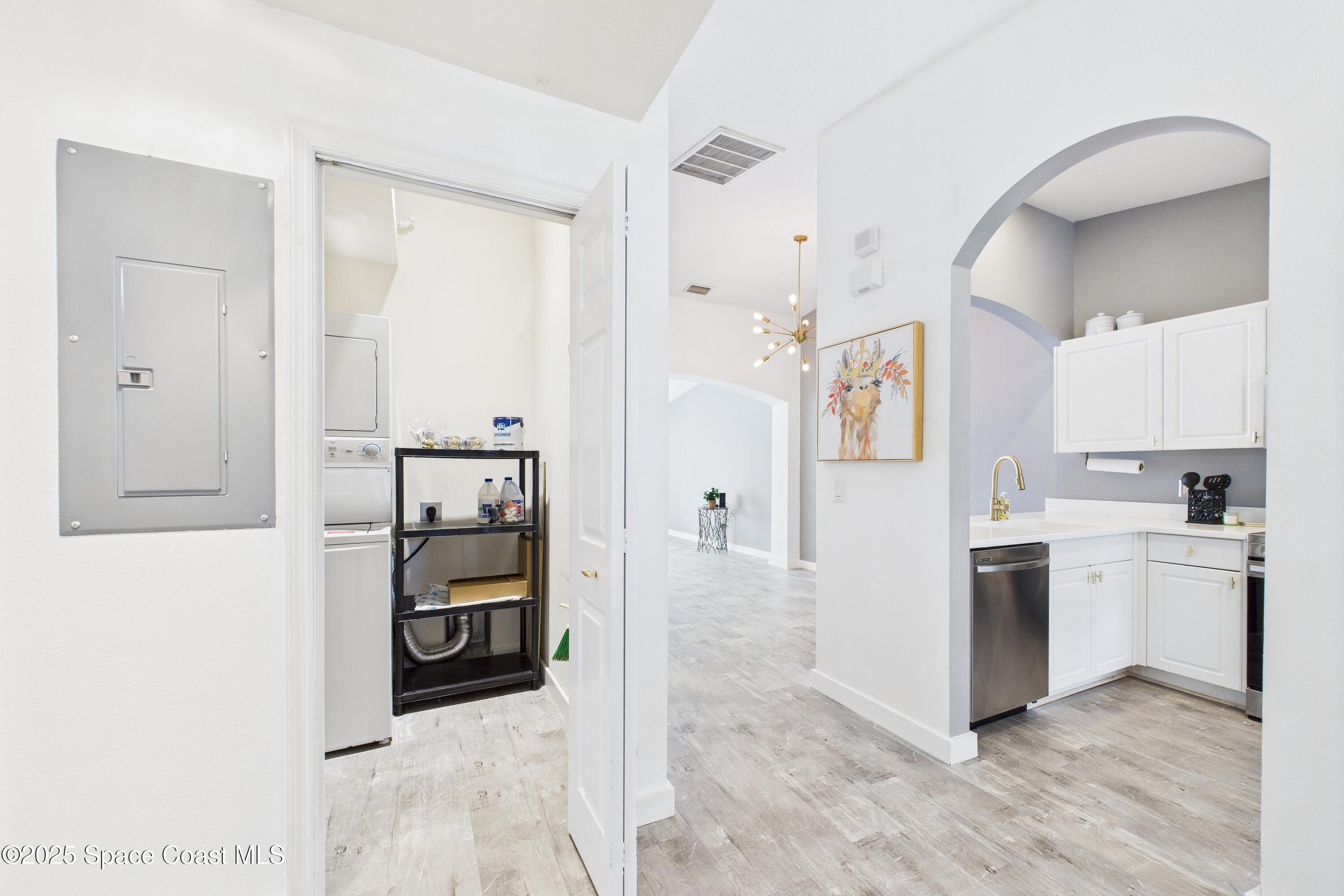 1010 Luminary Circle, Unit 104 Melbourne, FL 32901 - Photo 31 of 42 a kitchen with stainless steel appliances granite countertop a refrigerator and a stove top oven