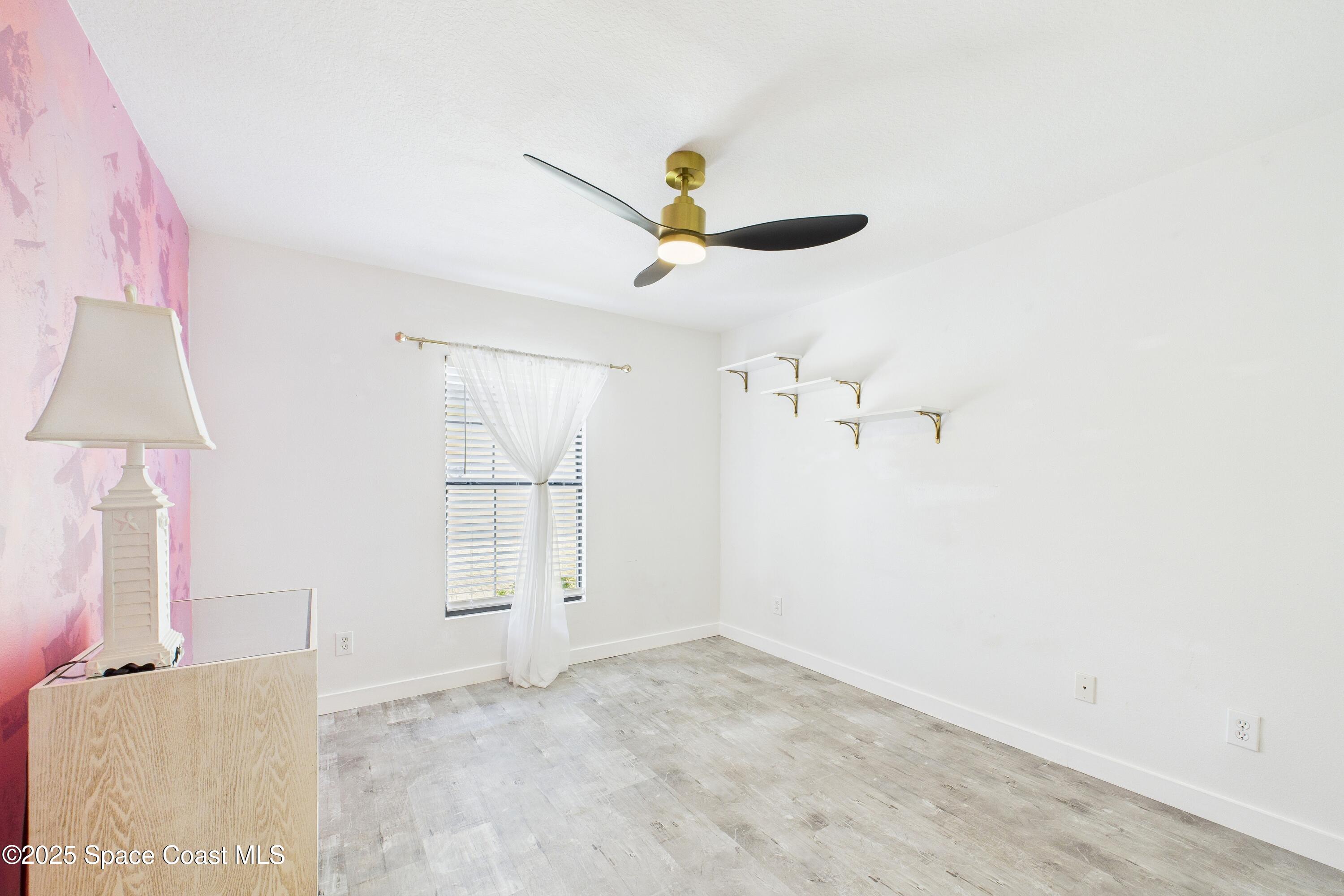 1010 Luminary Circle, Unit 104 Melbourne, FL 32901 - Photo 35 of 42 a view of a livingroom with a ceiling fan and window