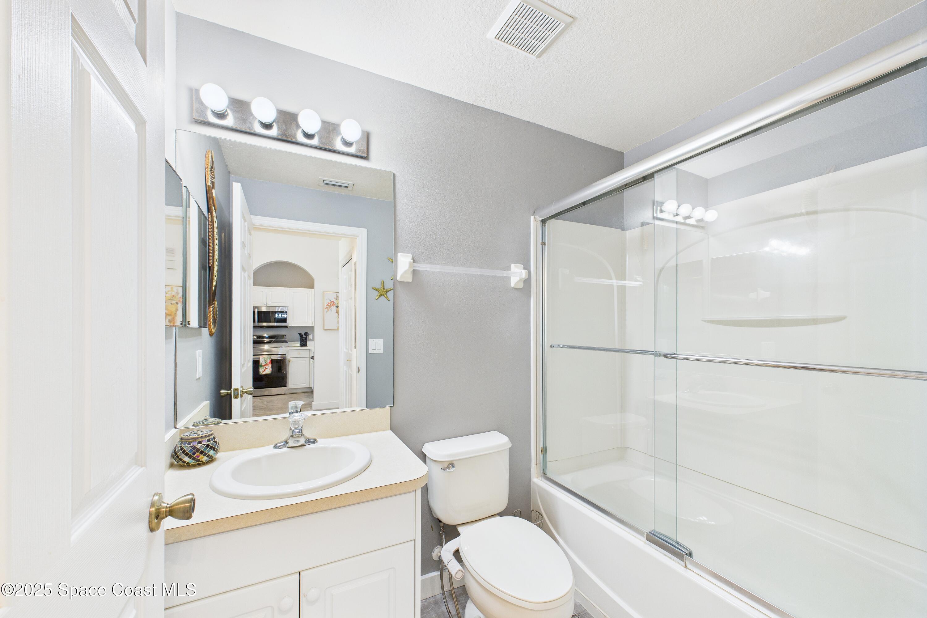 1010 Luminary Circle, Unit 104 Melbourne, FL 32901 - Photo 38 of 42 a bathroom with a sink a toilet and shower