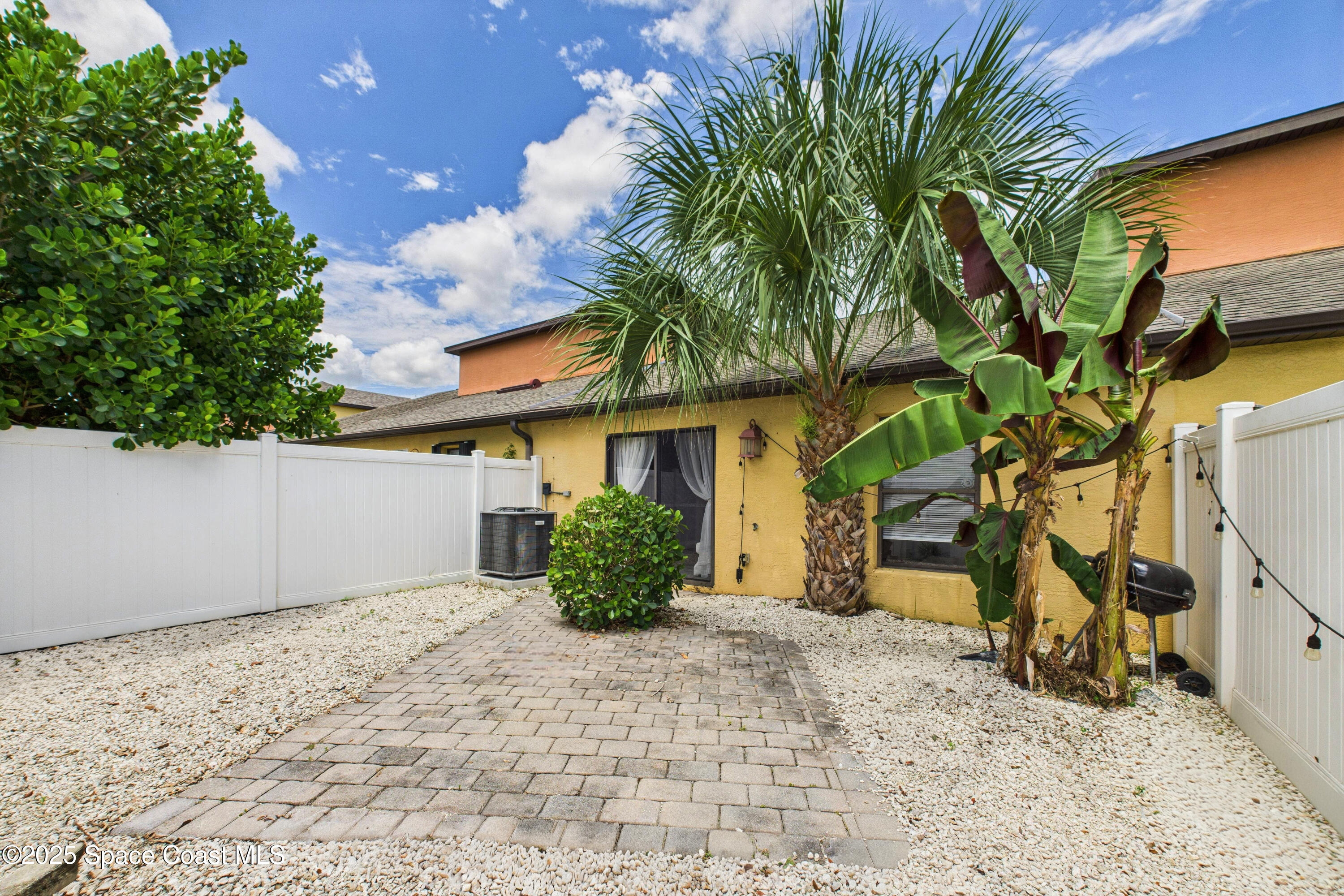 1010 Luminary Circle, Unit 104 Melbourne, FL 32901 - Photo 39 of 42 a front view of a house with a yard