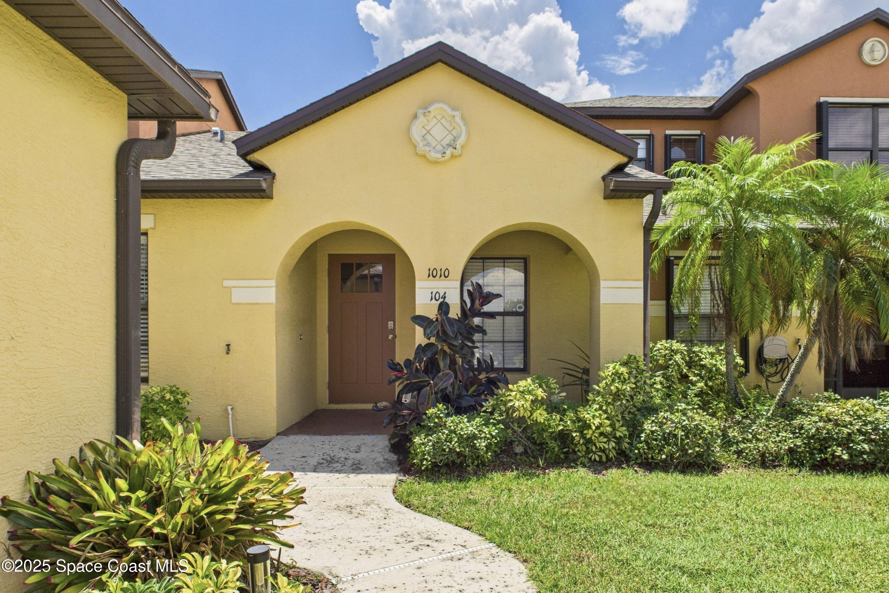 1010 Luminary Circle, Unit 104 Melbourne, FL 32901 - Photo 41 of 42 a front view of a house with garden
