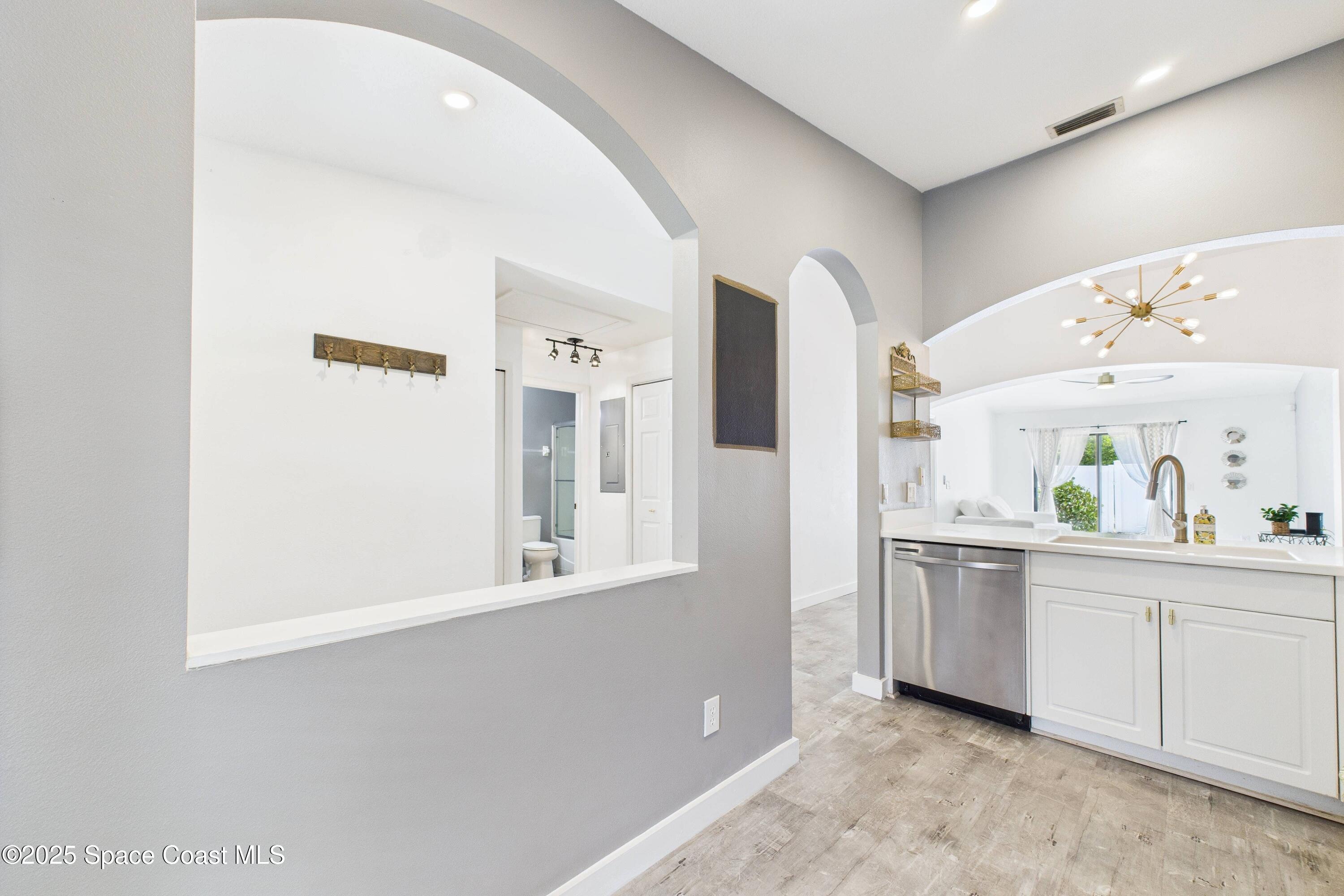 1010 Luminary Circle, Unit 104 Melbourne, FL 32901 - Photo 9 of 42 a view of a kitchen with white cabinets and window