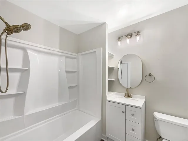 a bathroom with a toilet sink and a mirror