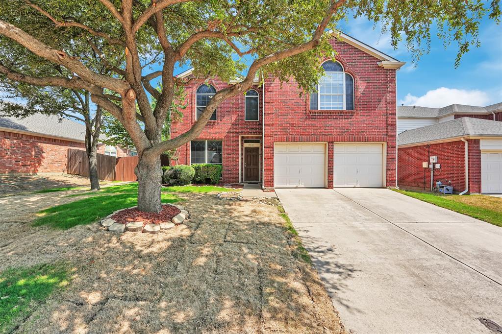 2101 Loon Lake Road Denton, TX 76210 - Photo 1 of 1 a front view of a house with a garden and trees