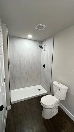 a bathroom with a toilet and a shower