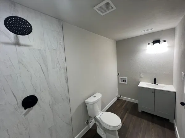 a bathroom with a toilet and a shower