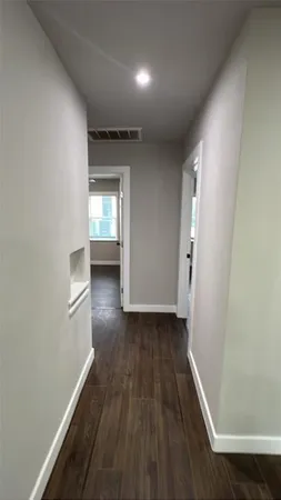 a view of hallway with wooden floor