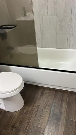 a bathroom with a toilet and a shower
