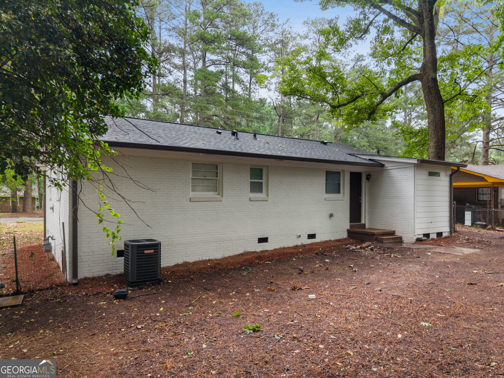 3567 Forrest Park Road Southeast Atlanta, GA 30354 - Photo 24 of 29 a backyard of a house with large trees and a barn