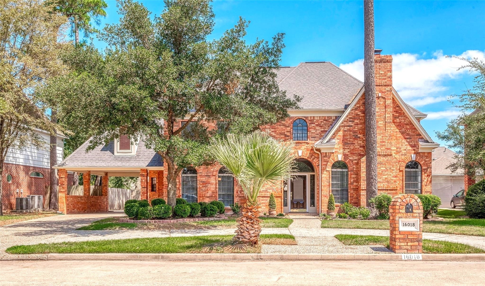 a view of a brick building next to a yard