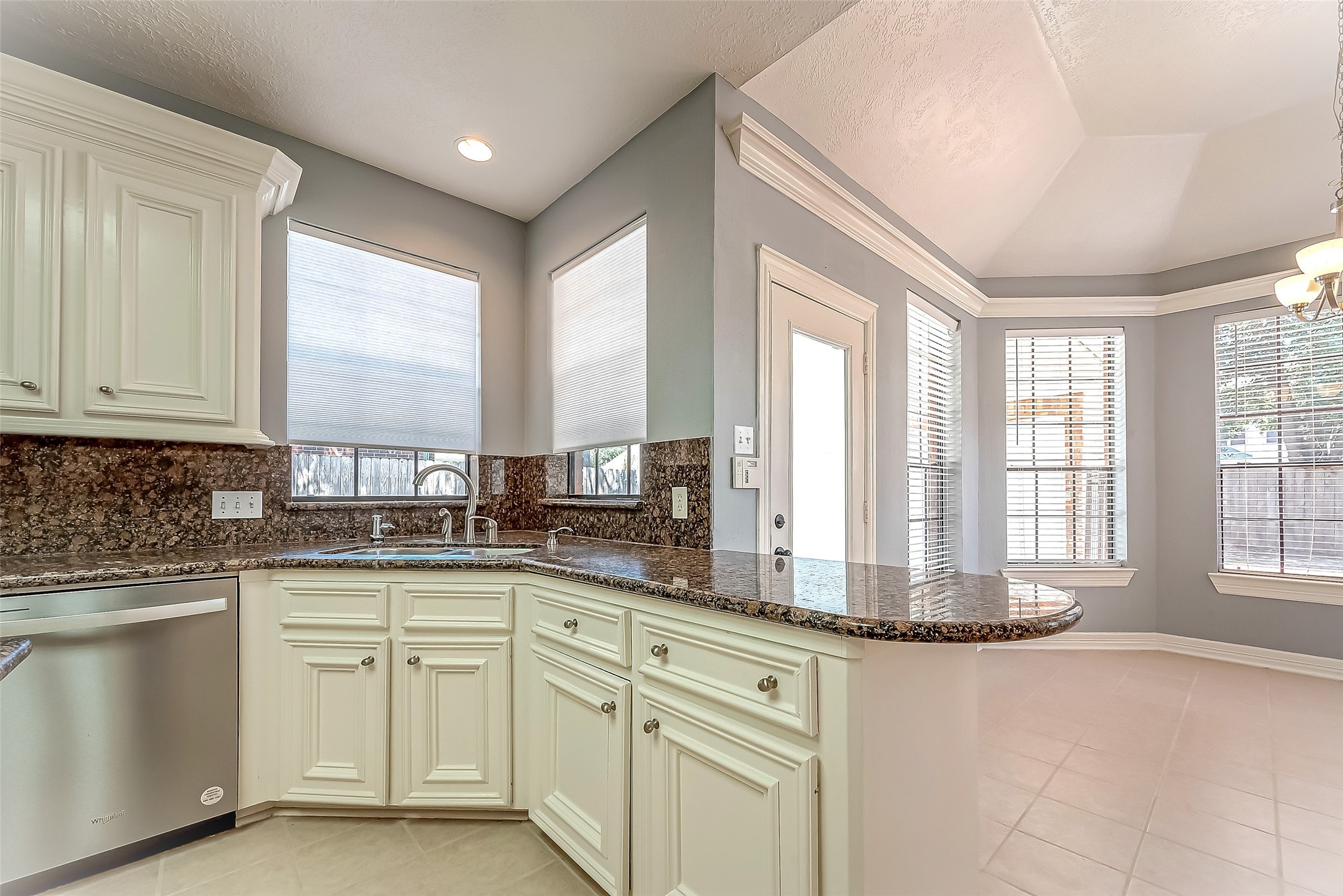 16018 Conners Ace Drive Spring, TX 77379 - Photo 17 of 47 a kitchen with white cabinets and sink