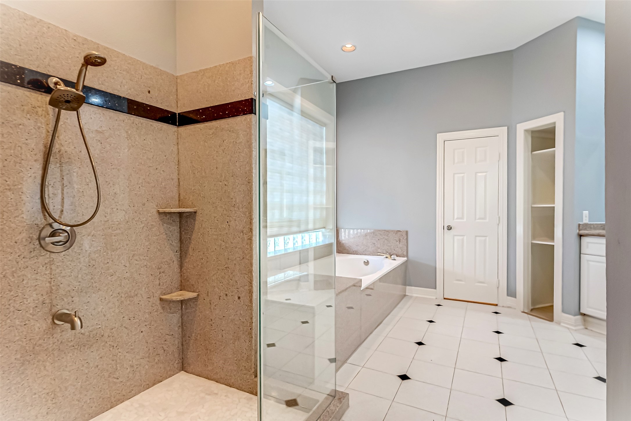 16018 Conners Ace Drive Spring, TX 77379 - Photo 23 of 47 a bathroom with a tub shower and mirror