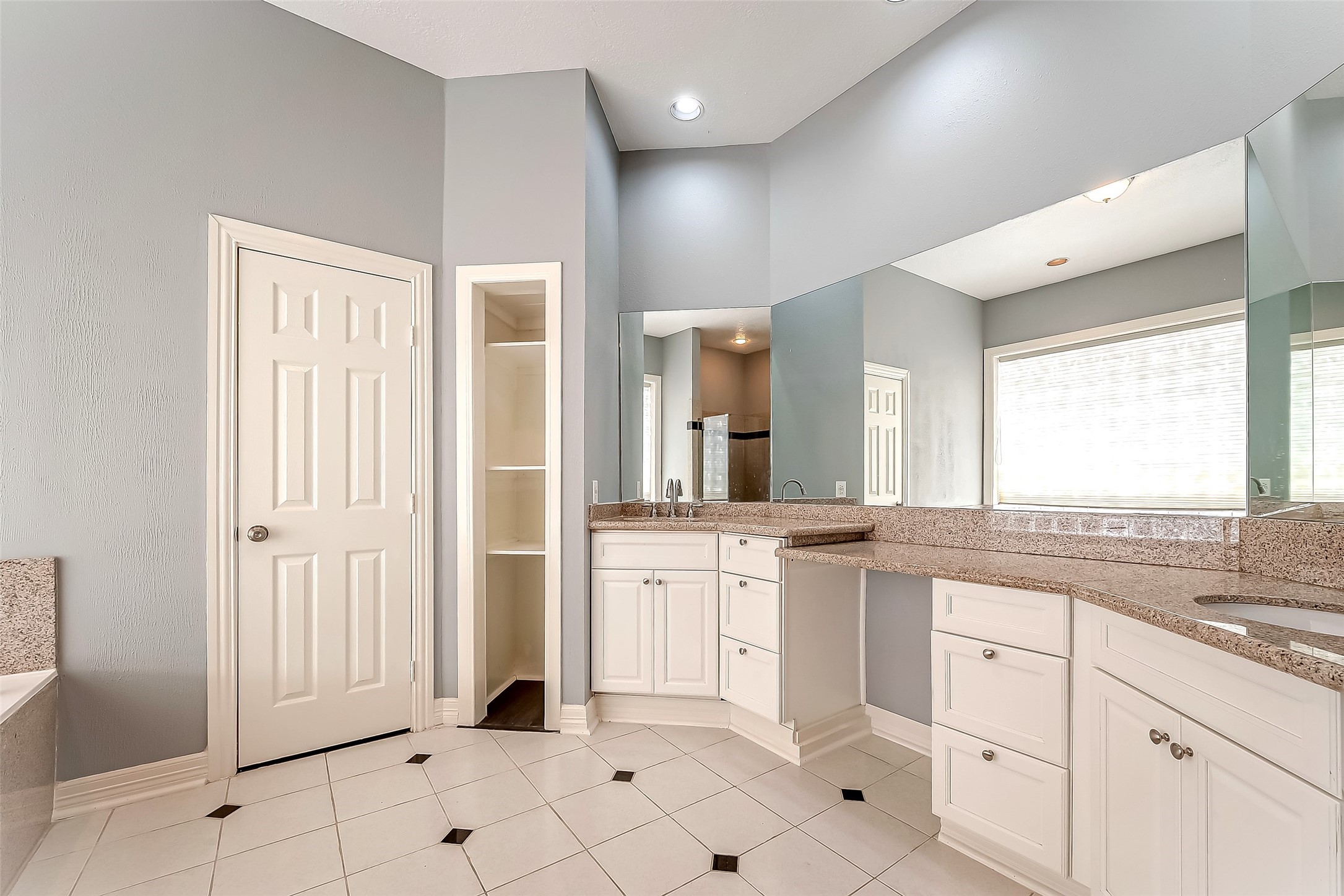 16018 Conners Ace Drive Spring, TX 77379 - Photo 25 of 47 a large white kitchen with granite countertop white cabinets and white appliances