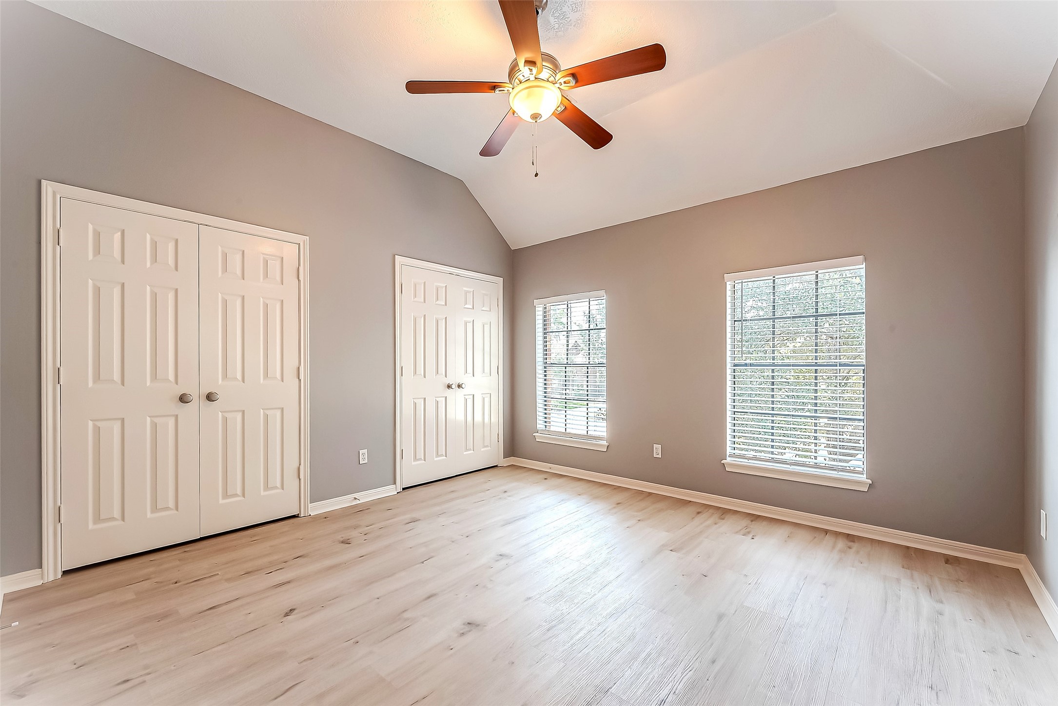 16018 Conners Ace Drive Spring, TX 77379 - Photo 29 of 47 an empty room with wooden floor chandelier fan and windows