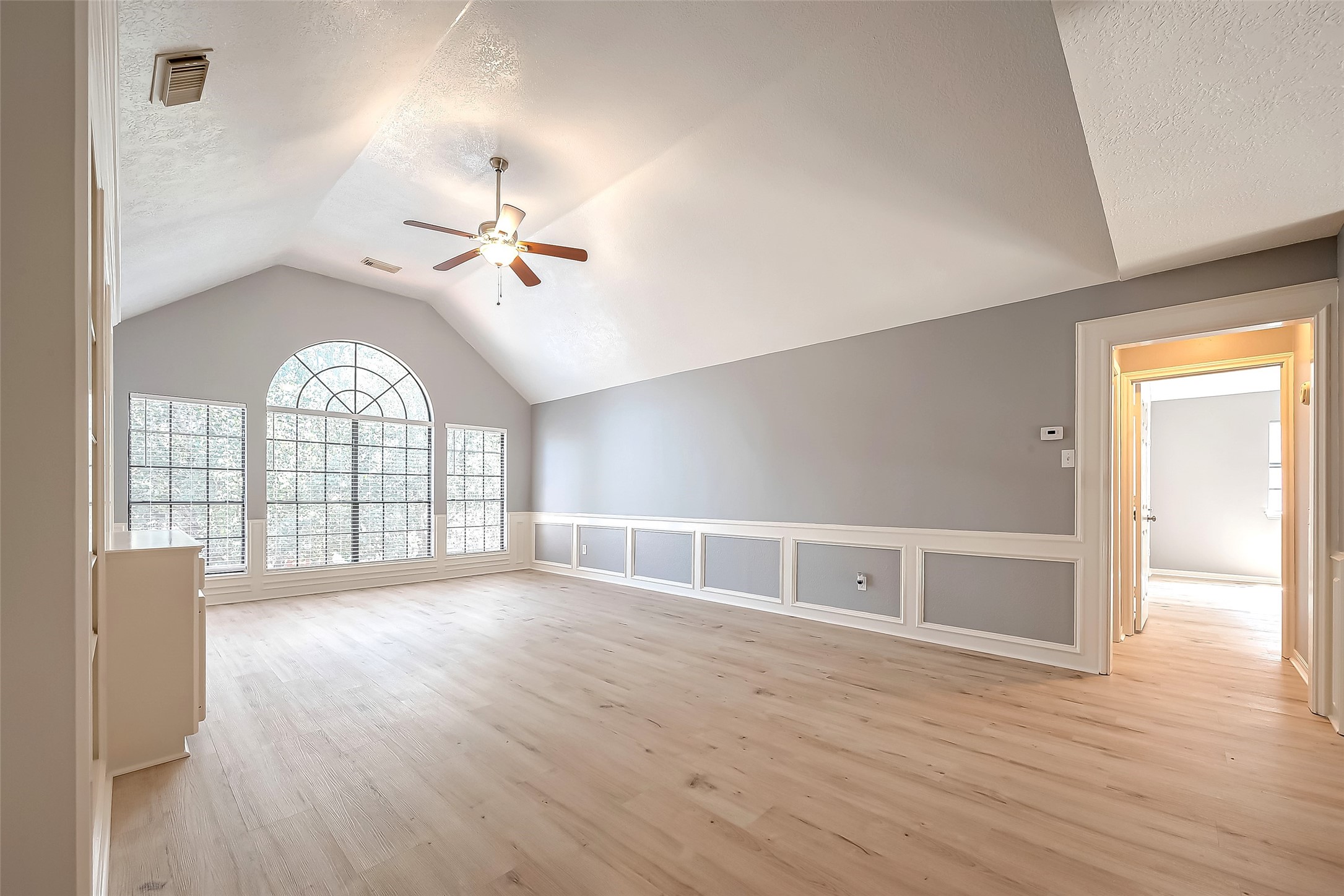 16018 Conners Ace Drive Spring, TX 77379 - Photo 37 of 47 an empty room with wooden floor fan and windows