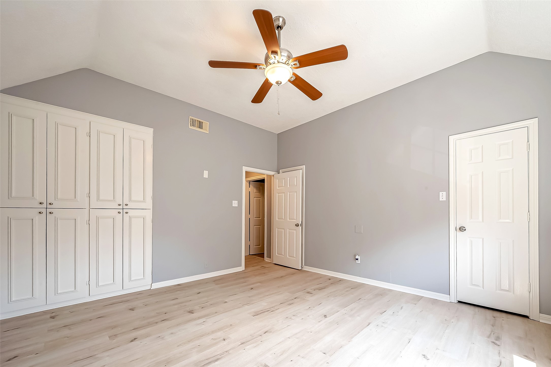 16018 Conners Ace Drive Spring, TX 77379 - Photo 42 of 47 an empty room with wooden floor ceiling fan and windows