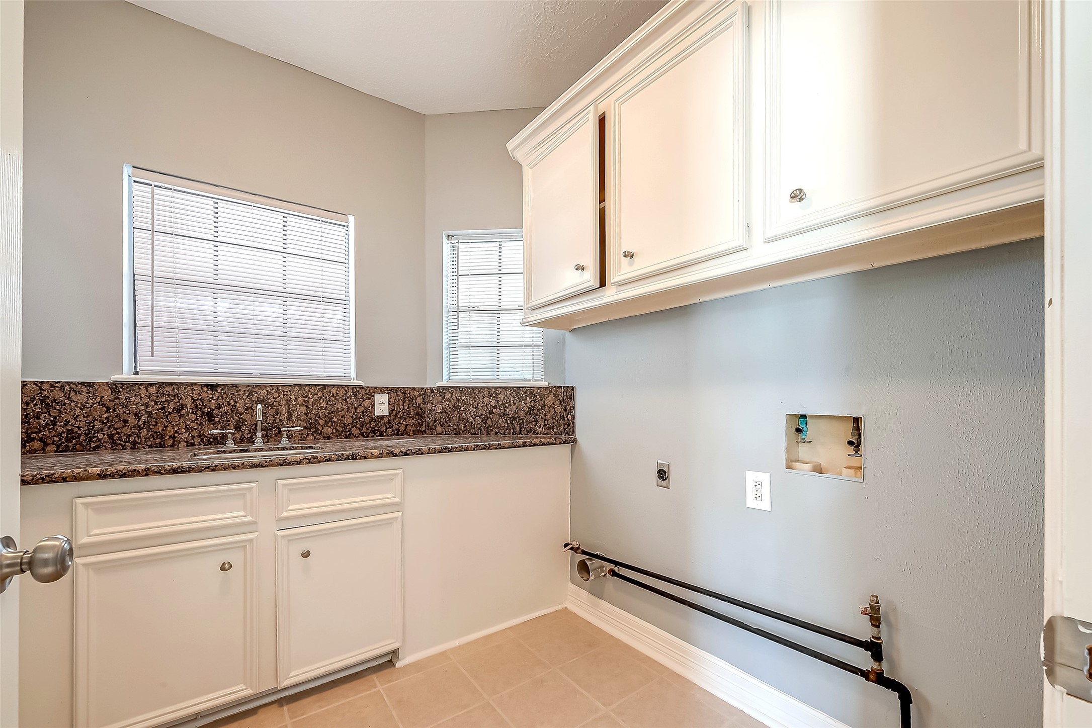 16018 Conners Ace Drive Spring, TX 77379 - Photo 45 of 47 a kitchen with granite countertop white cabinets and white appliances