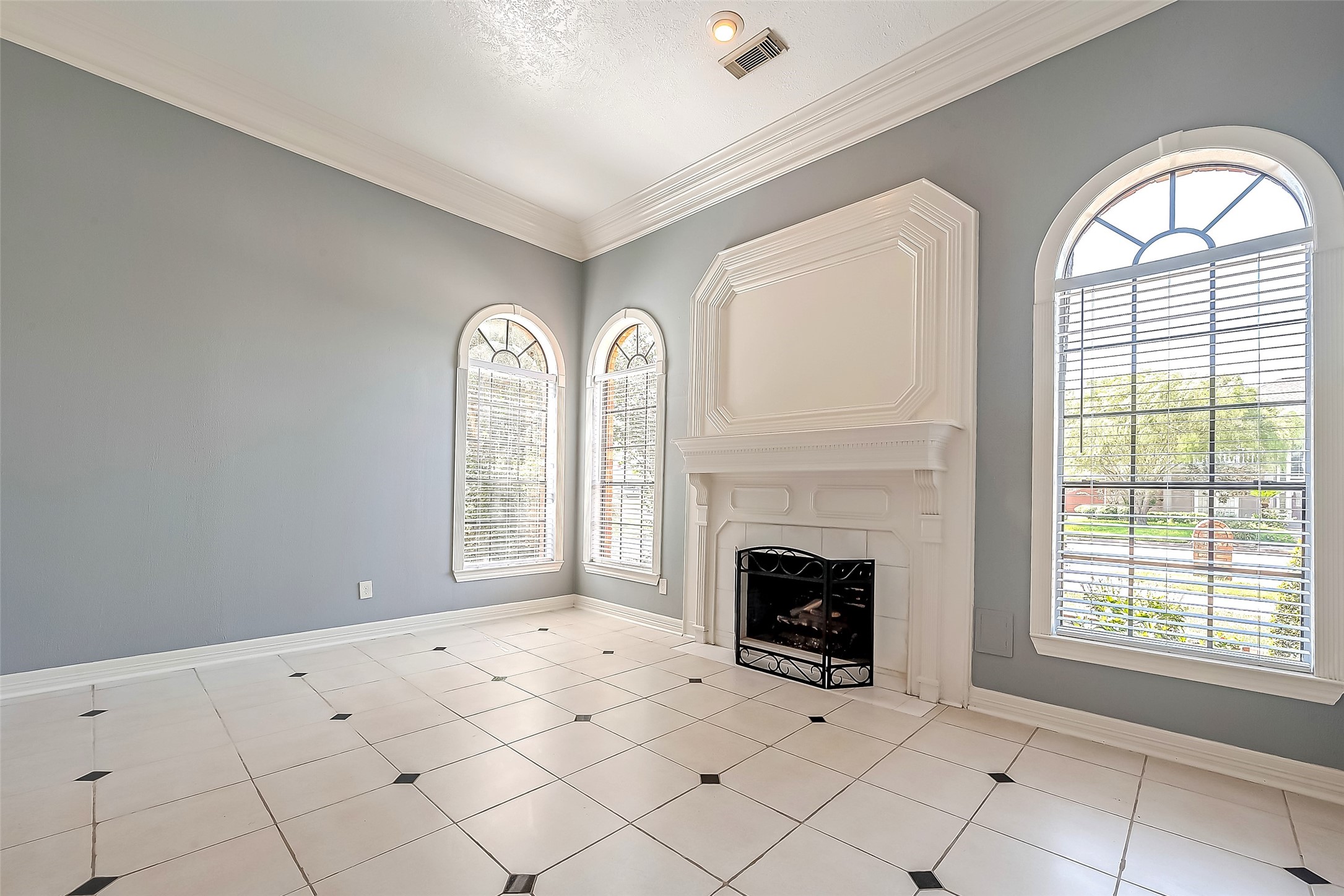 16018 Conners Ace Drive Spring, TX 77379 - Photo 8 of 47 an empty room with windows fireplace and fans