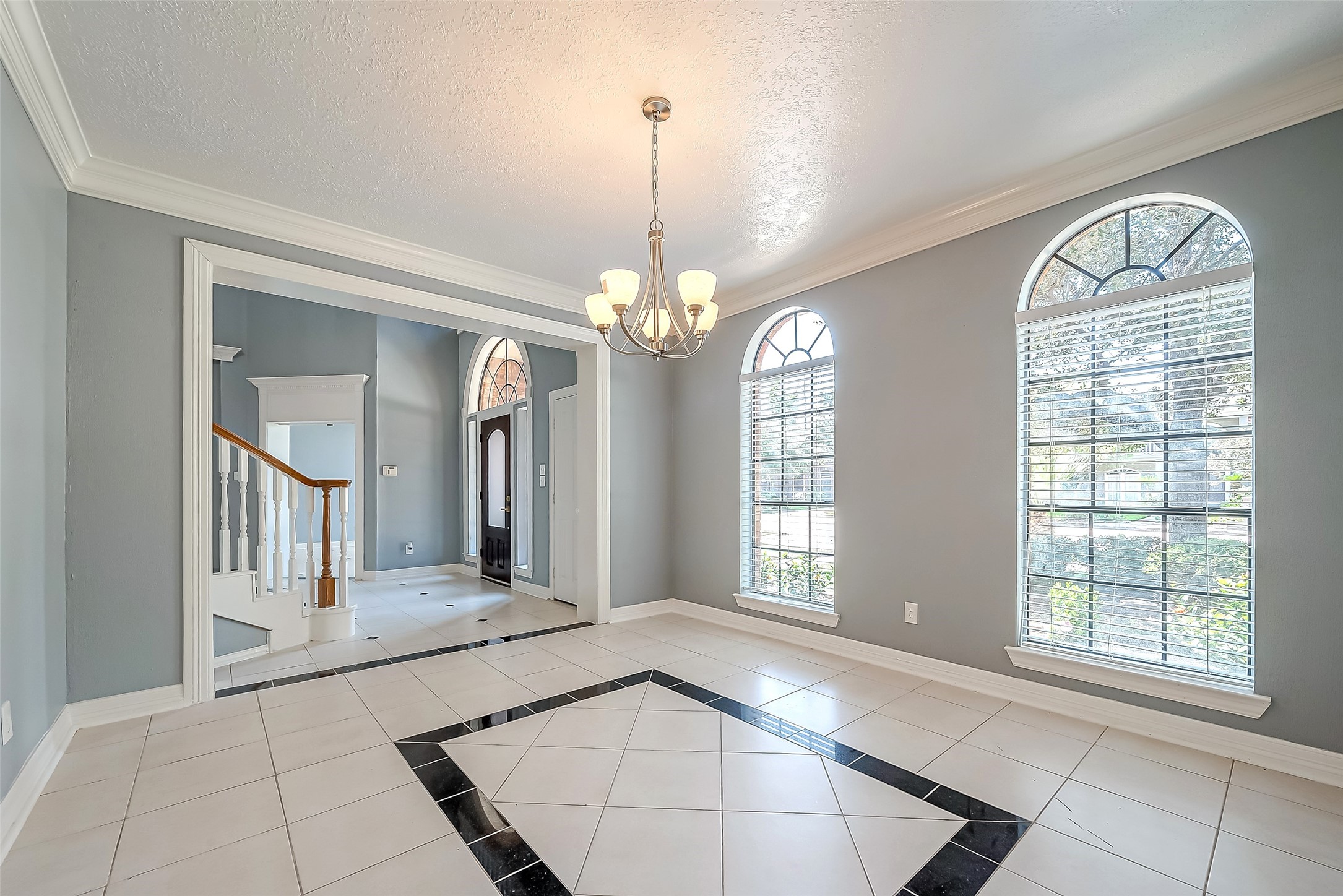 16018 Conners Ace Drive Spring, TX 77379 - Photo 10 of 47 a view of a big room with windows and chandelier
