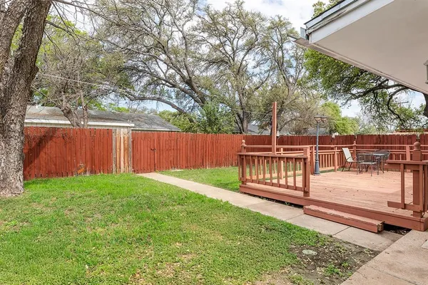 a view of a house with a wooden deck