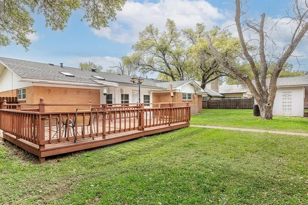 a balcony with wooden floor and fence