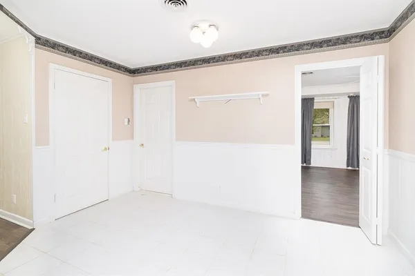 a view of a big room with wooden floor and windows