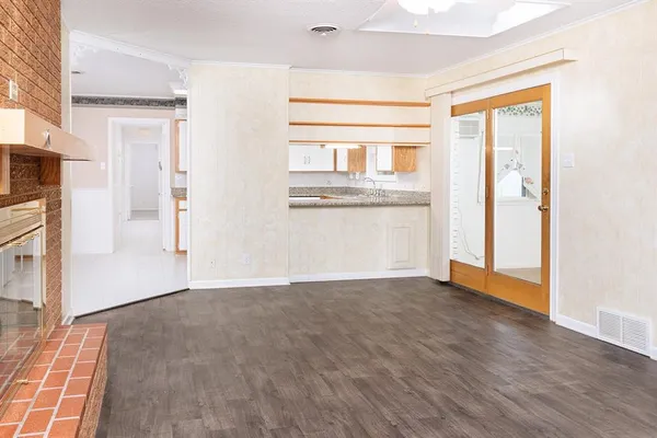 a bathroom with a granite countertop sink a large mirror and a bathtub