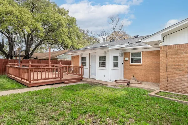 a view of large house with a big yard and large trees