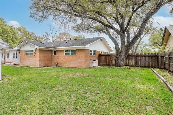 a view of a backyard with large trees