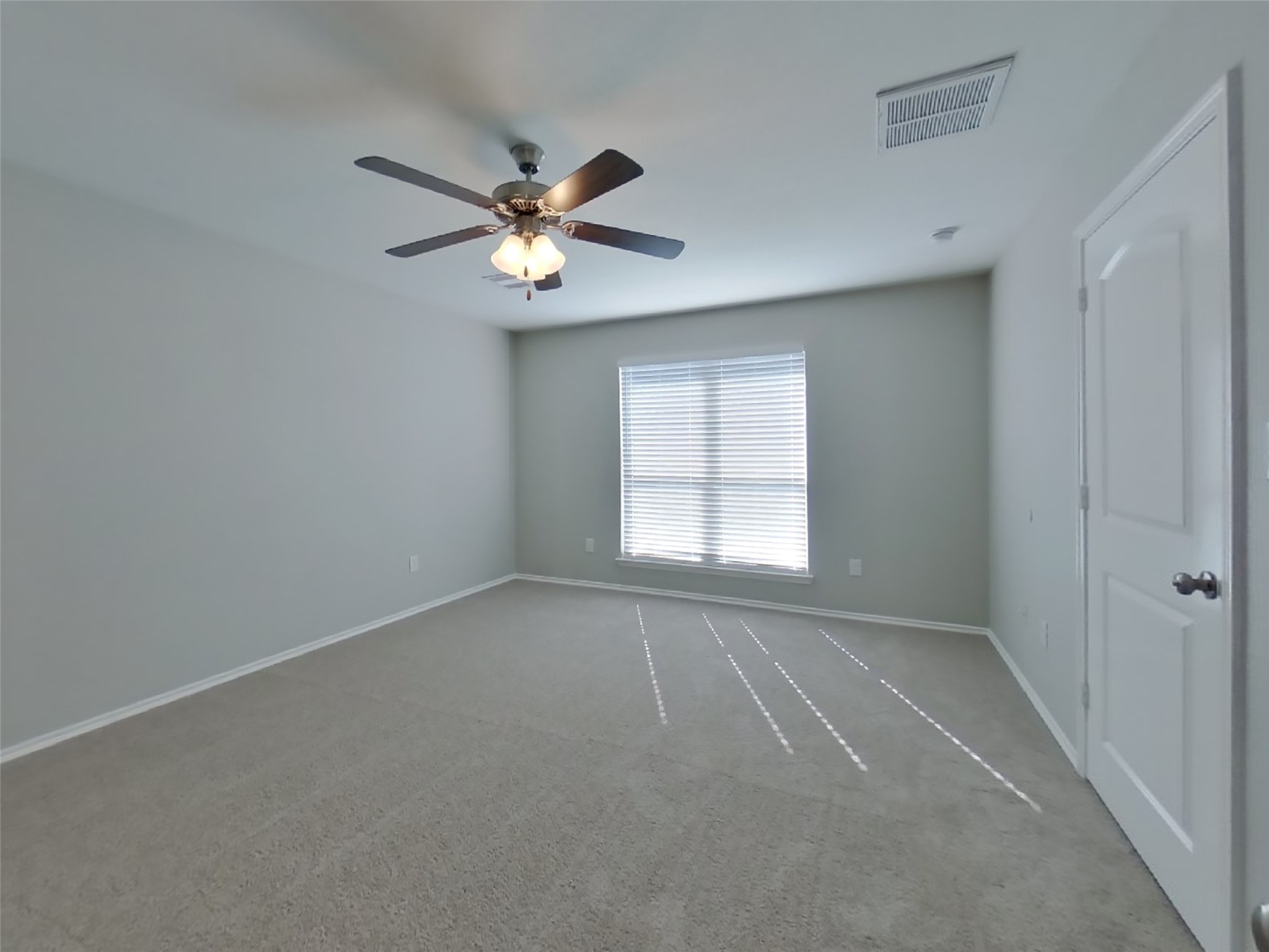 1937 Briar Grove Drive Conroe, TX 77301 - Photo 11 of 18 an empty room with windows and ceiling fan