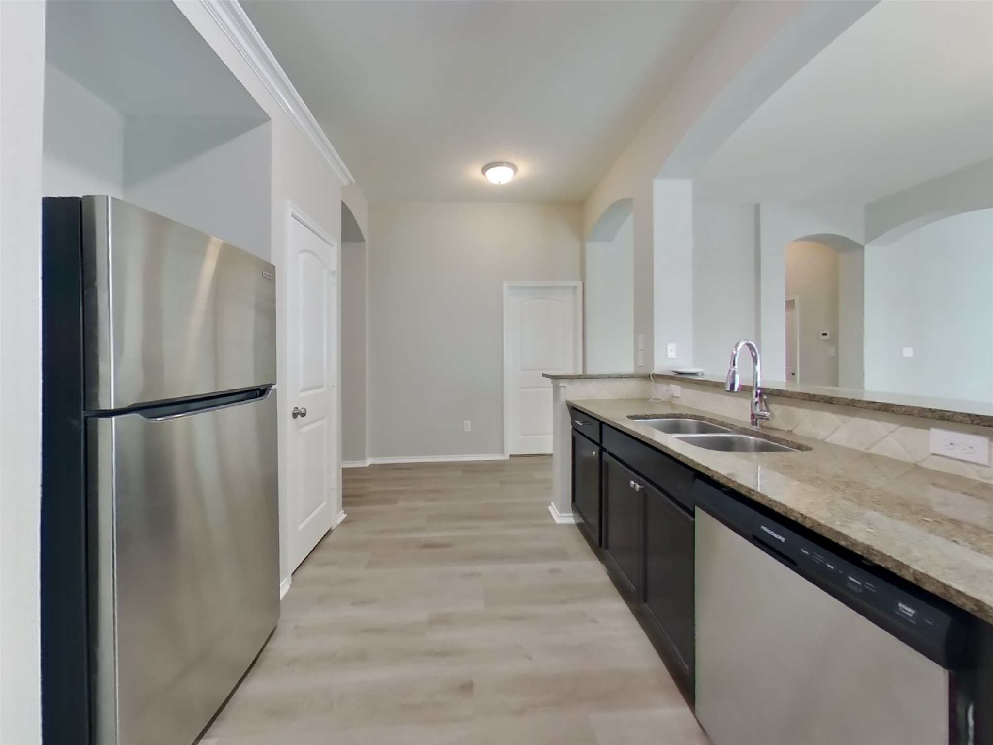 1937 Briar Grove Drive Conroe, TX 77301 - Photo 7 of 18 a kitchen with stainless steel appliances granite countertop a refrigerator and a sink