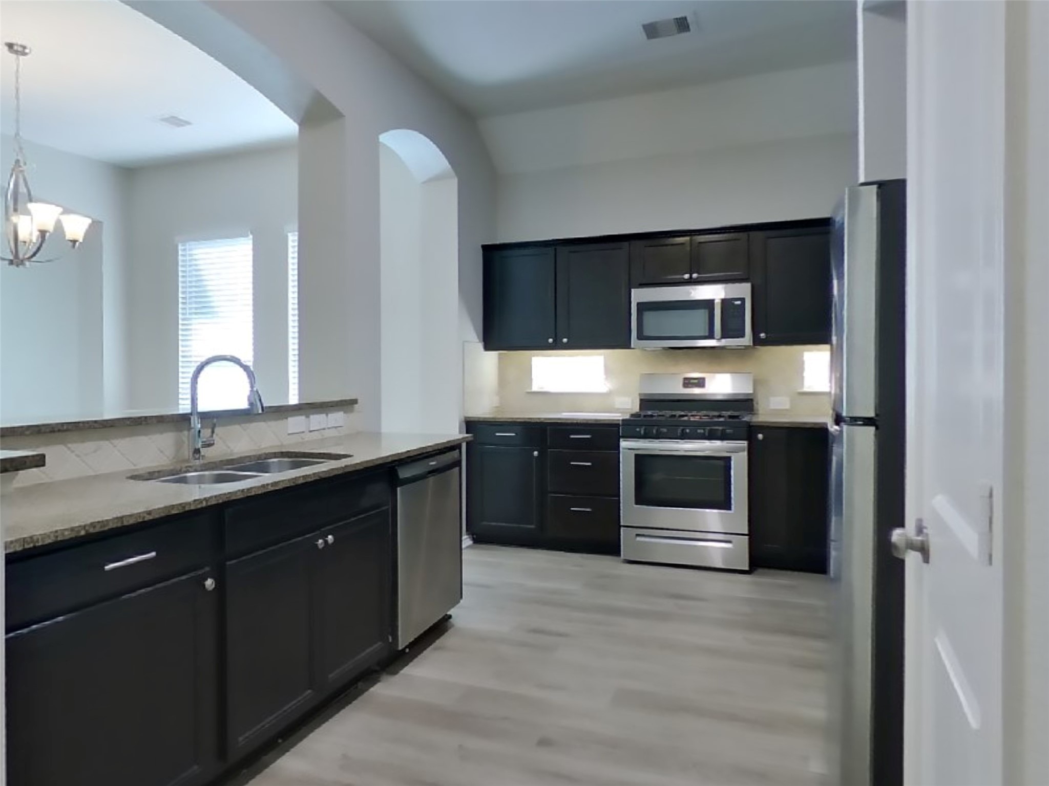 1937 Briar Grove Drive Conroe, TX 77301 - Photo 8 of 18 a kitchen with stainless steel appliances granite countertop a stove and a sink