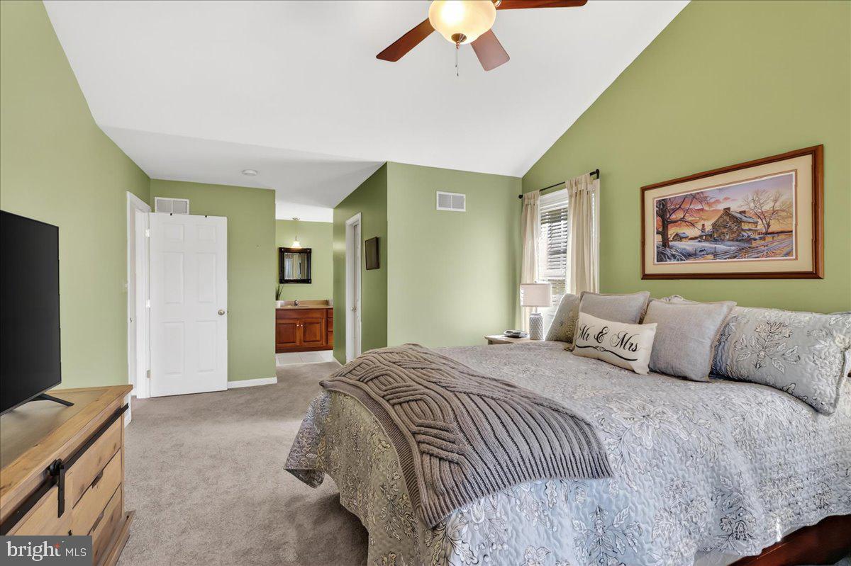 2 Parkside Drive Elverson, PA 19520 - Photo 14 of 39 a bedroom with a large bed and a chandelier