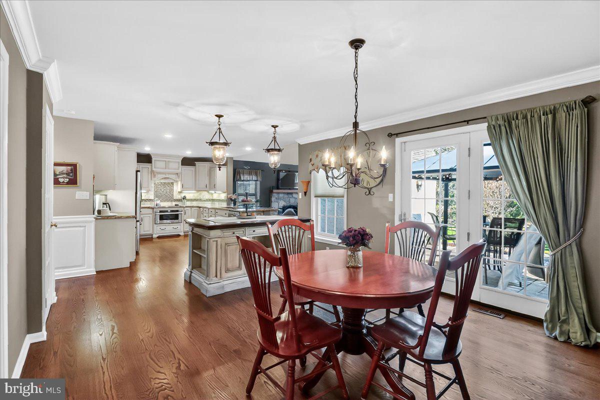 2 Parkside Drive Elverson, PA 19520 - Photo 5 of 39 a view of a dining room and livingroom with furniture wooden floor a chandelier