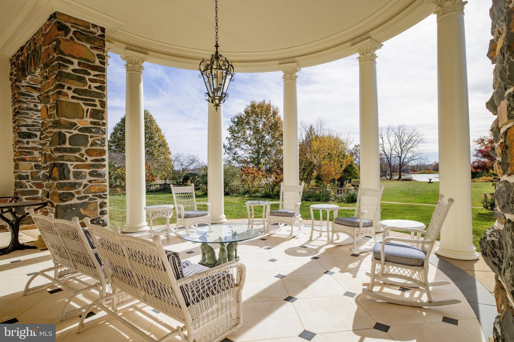 21846 Trappe Road Upperville, VA 20184 - Photo 19 of 50 a living room with large windows and a chandelier