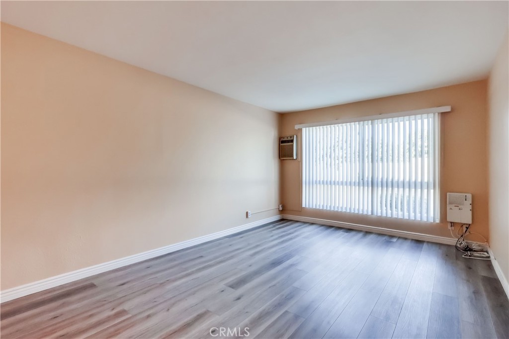 5585 Pacific Coast Highway, Unit 140 Long Beach, CA 90804 - Photo 12 of 47 a view of an empty room with wooden floor and a window