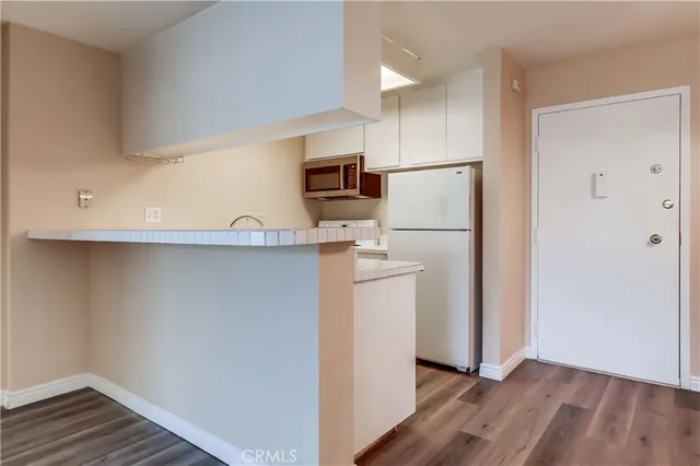 a kitchen with a refrigerator and a microwave