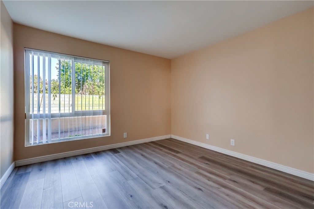5585 Pacific Coast Highway, Unit 140 Long Beach, CA 90804 - Photo 20 of 47 a view of an empty room with wooden floor and a window