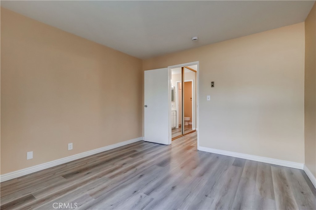 5585 Pacific Coast Highway, Unit 140 Long Beach, CA 90804 - Photo 21 of 47 a view of an empty room and wooden floor